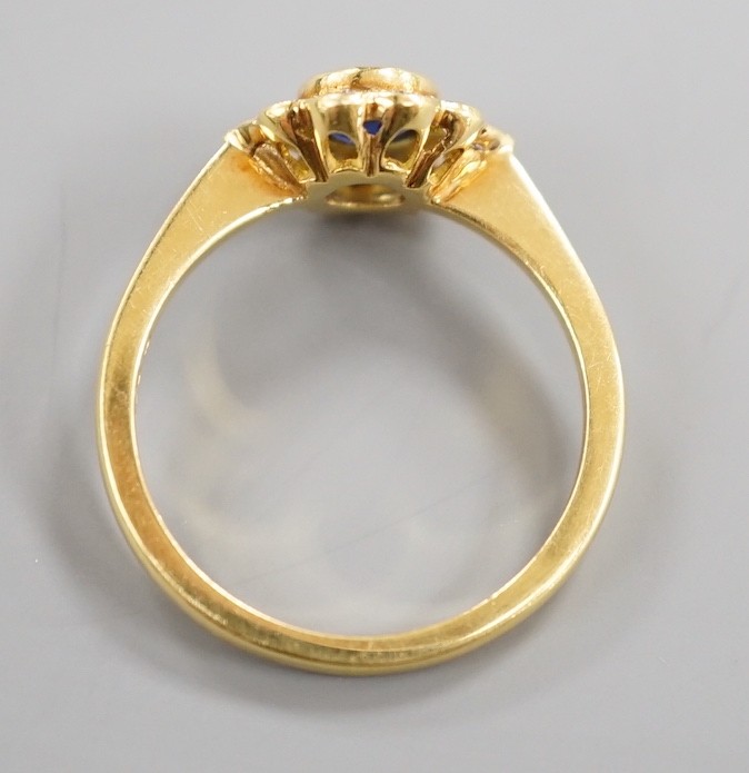 A modern 18ct gold, collet set sapphire and diamond set circular cluster ring, size O, gross weight 3.6 grams